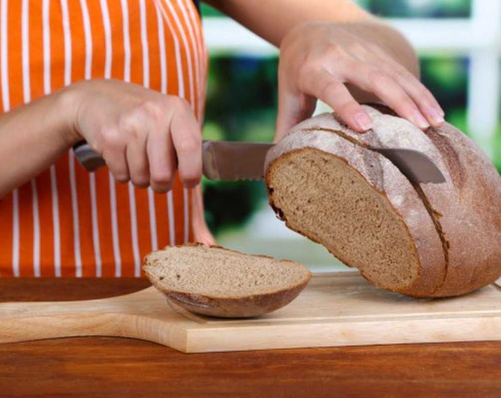 Человек есть много хлеба. Хлеб. Черный хлеб. Хлеб традиционный. Ржаной хлеб.